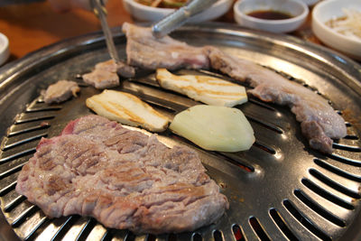 Korean grilled pork bbq or samgyeopsal-gui with charcoal at korean restaurant, busan, south korea