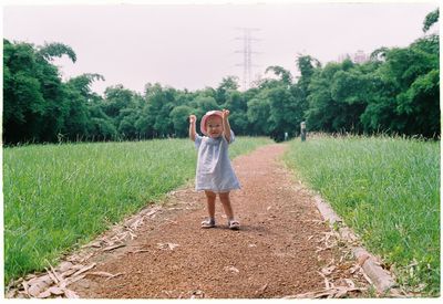 Full length of cute baby girl standing on land