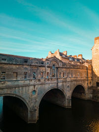 Arch bridge against blue sky