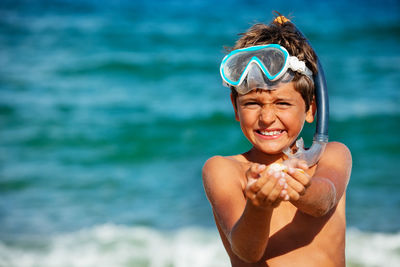 Portrait of young man swimming in sea