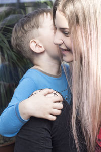 Cute brother kissing sister at back yard