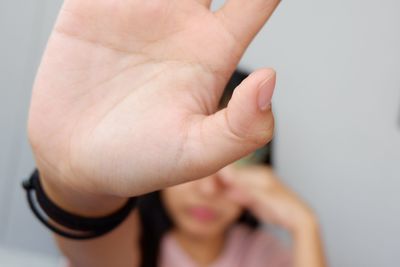 Close-up of woman gesturing stop sign