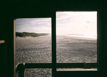 Scenic view of field seen through window