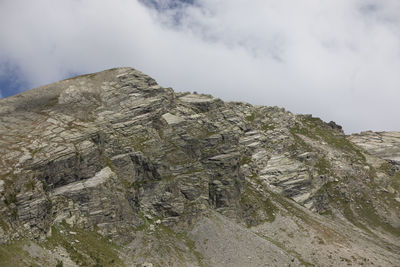 Rock formations by mountain against sky