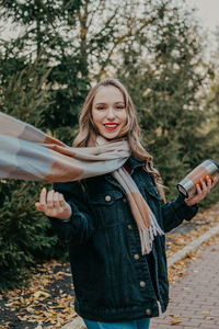 Smiling girl standing against tree