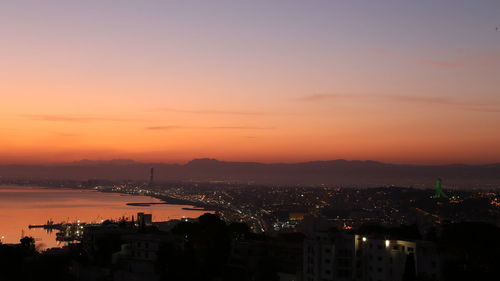 High angle view of illuminated buildings against sky during sunset