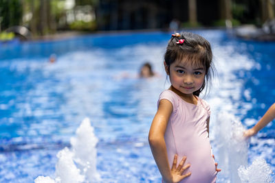 Portrait of cute girl in swimming pool