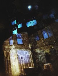 Low angle view of illuminated building at night