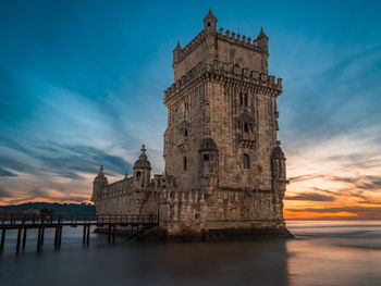 Low angle view of historical building against sky during sunset