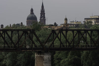 View of bridge and buildings against sky in city