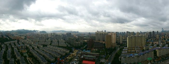 High angle view of cityscape against cloudy sky