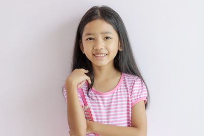 Portrait of a smiling girl over white background