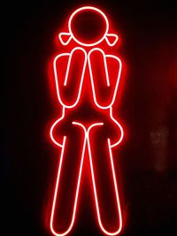 Illuminated human representation against black background