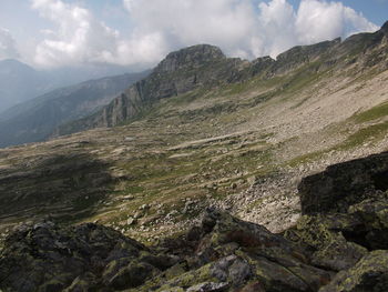 Scenic view of mountains against cloudy sky