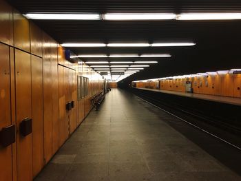 Empty illuminated railroad station platform