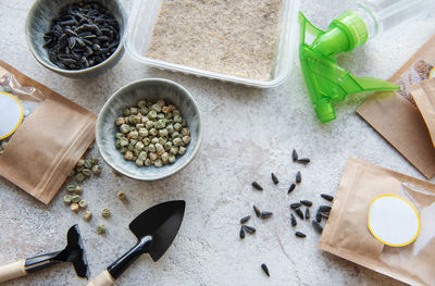 Microgreen seeds in paper bags and microgreen sowing equipment on the table. healthy food.