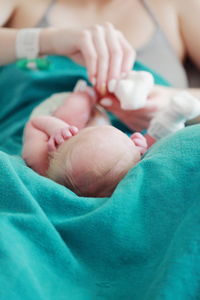 Close-up of mother with newborn baby in hospital