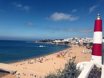 Scenic view of beach by sea against sky