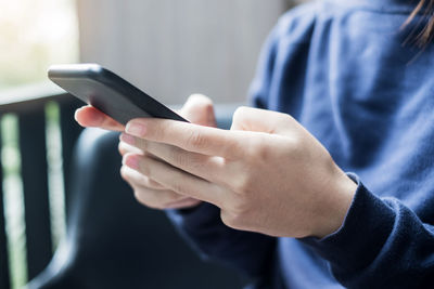 Midsection of man using mobile phone