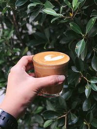 Close-up of hand holding coffee