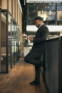 Full length of young man standing in train