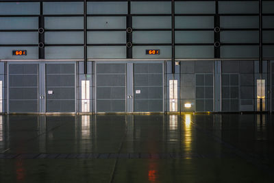 Reflection of illuminated building on glass window at night