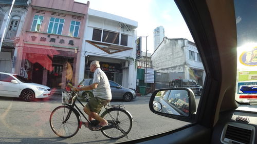 Man riding bicycle in city