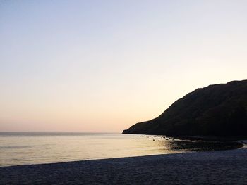 Scenic view of sea against clear sky at sunset