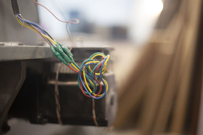 Close-up of multi colored hanging on cable