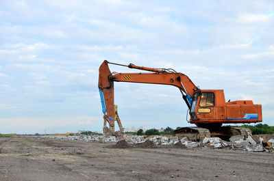 Crane at construction site against sky