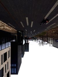 Silhouette buildings in city during winter