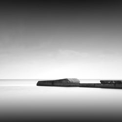 Pier amidst sea against sky during foggy weather