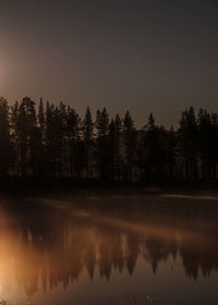 Scenic view of lake against sky at night