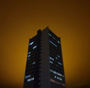Low angle view of buildings against sky at night
