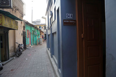 Footpath amidst buildings in city