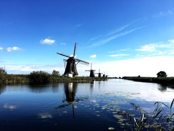 Windmills against sky