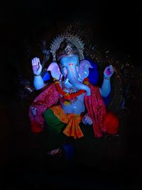 Close-up of statue against black background