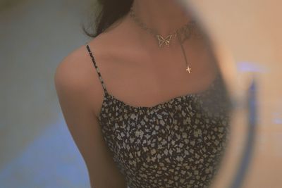 Midsection of woman wearing necklace