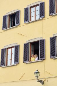 Low angle view of bird perching on building