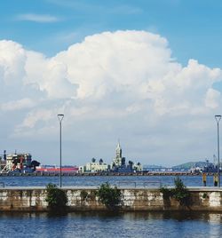 Buildings by river against sky - fiscal islândia, rio de janeiro, brazil