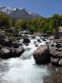 Scenic view of waterfall against sky