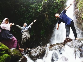 People on rocks by river