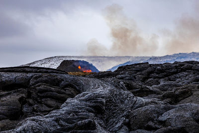 Scenic view of volcanic mountain against sky