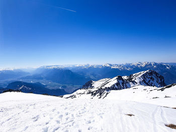 Scenic view of snowcapped mountains against clear blue sky