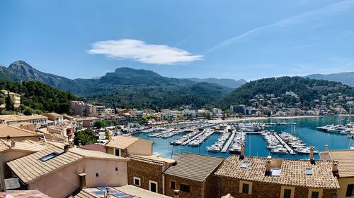 High angle view of townscape by sea against sky