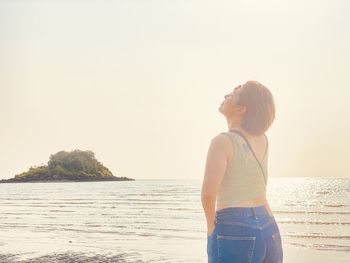 Man looking at sea against clear sky