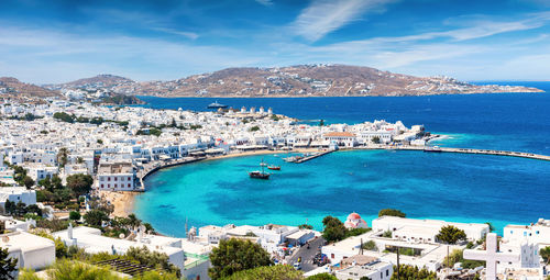 High angle view of sea and cityscape against sky