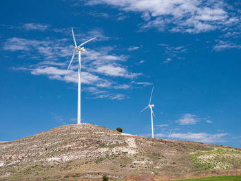 Low angle view of wind turbine against sky