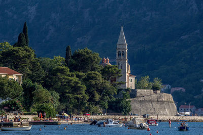 Cathedral by sea against mountain