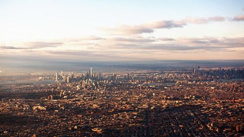 Cityscape against cloudy sky